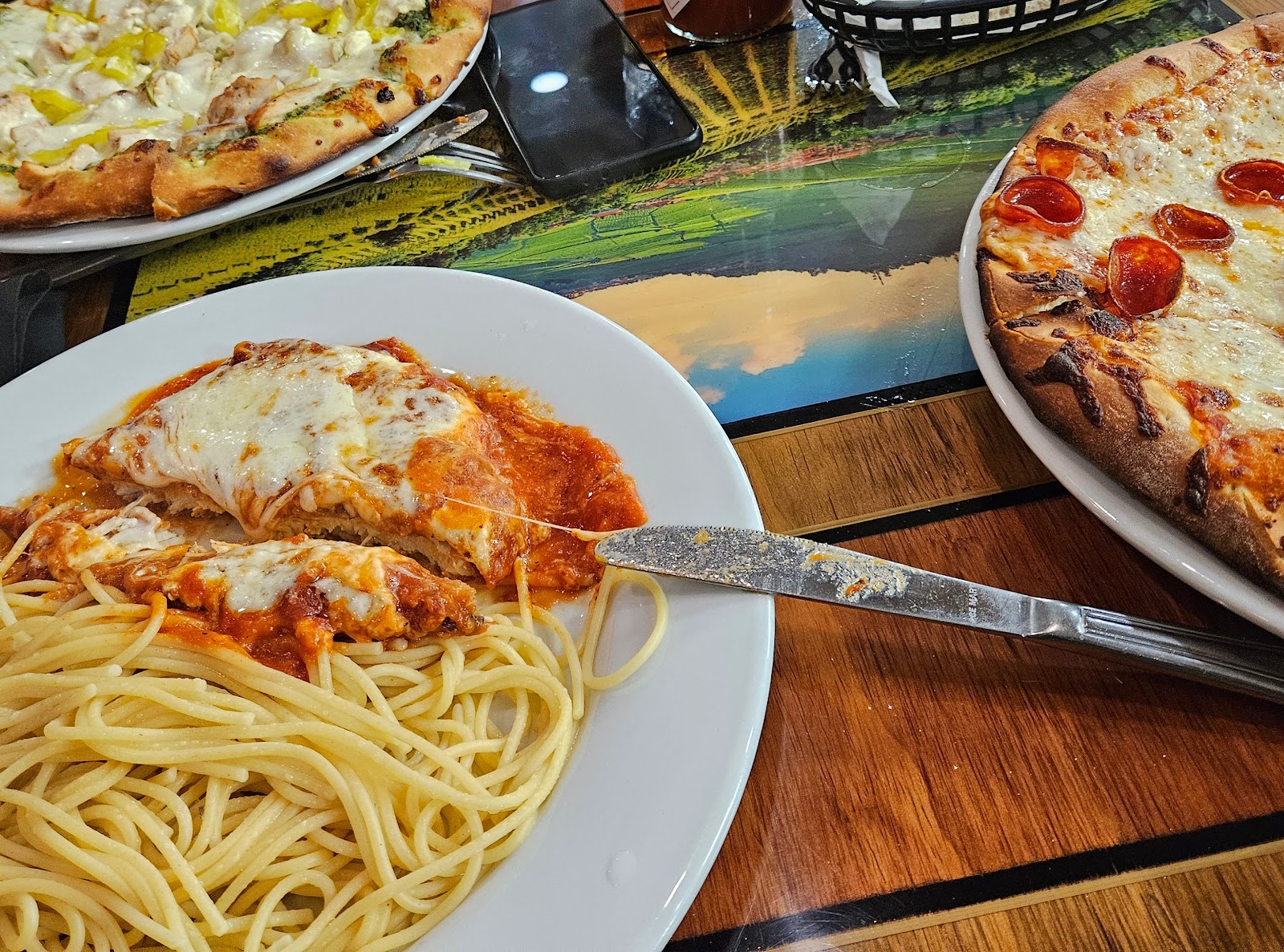 Pizza, chicken parmesan, and spaghetti spread at Casa Mía